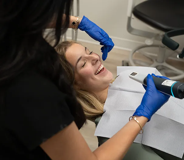 Dental Assistant Scanning Patient Using iTero