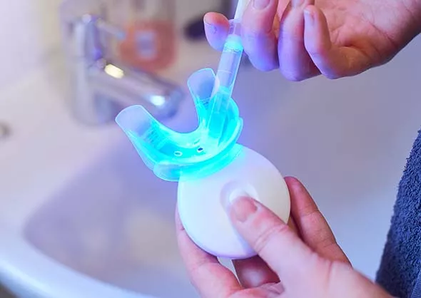Close up of hand held teeth whitening machine