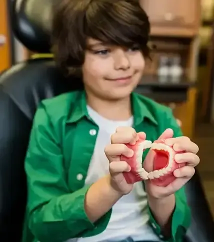 Young patient with dental model