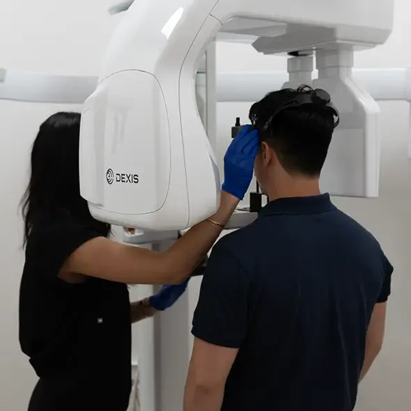 Dental Assistant positioning Patient in a 3D panoramic dental x-ray