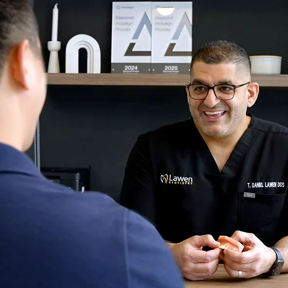 Dr. Daniel Lawen with Invisalign clear aligner in the patient consultation room at Mumford Road