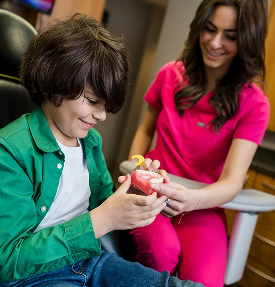 Dental Assistant with young patient chatting about a dental procedure