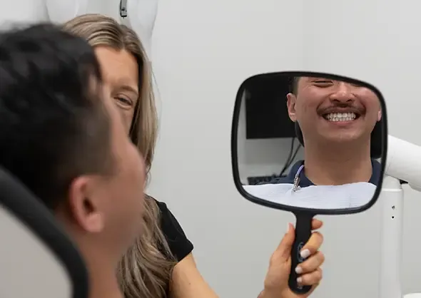 Examining results of dental procedure in mirror