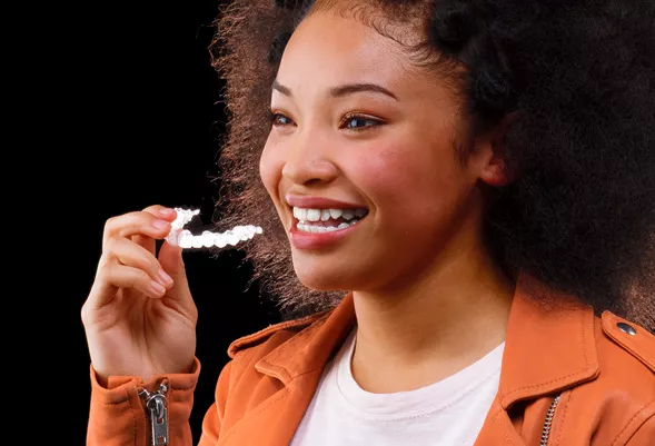 Woman inserting Invisalign clear aligner
